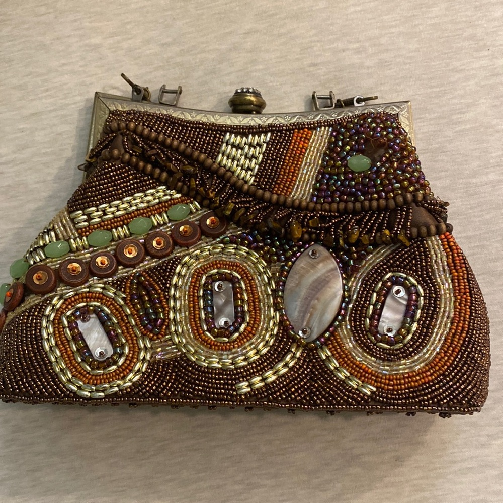 Unique handbeaded handbag with detachable strap and extra clutch design